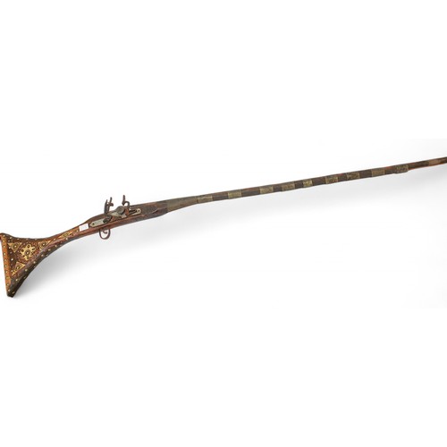 43 - A decorative Jezail long musket, together with a painted tribal mask, child's Maasai warrior shield ... 