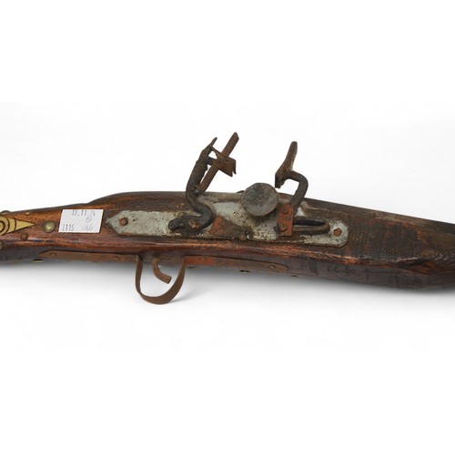 43 - A decorative Jezail long musket, together with a painted tribal mask, child's Maasai warrior shield ... 