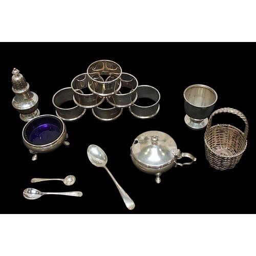 318 - A small collection of assorted silver items, comprising a set of six silver napkin rings by William ... 