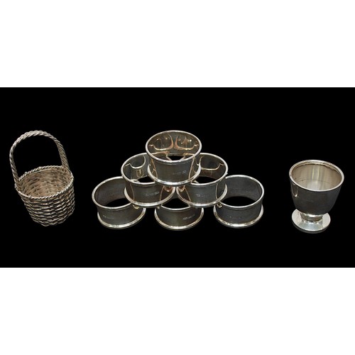 318 - A small collection of assorted silver items, comprising a set of six silver napkin rings by William ... 