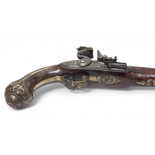 126 - An ornate 18th century flintlock pistol, possibly Irish, the 22cm steel barrel and lock cast with tr... 