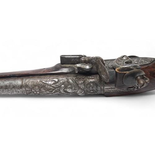 126 - An ornate 18th century flintlock pistol, possibly Irish, the 22cm steel barrel and lock cast with tr... 