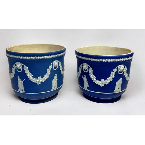 301 - Two similar dark blue Wedgwood Jasper 'dip' jardinières / planters, decorated in relief with lion ma... 