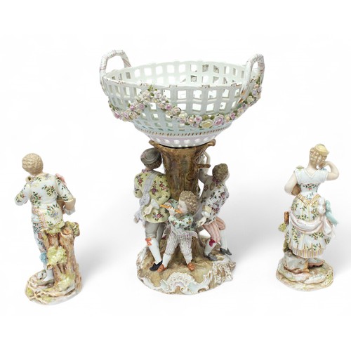 302 - A Sitzendorf porcelain comport, with pierced, floral encrusted top section, raised on figure-group s... 