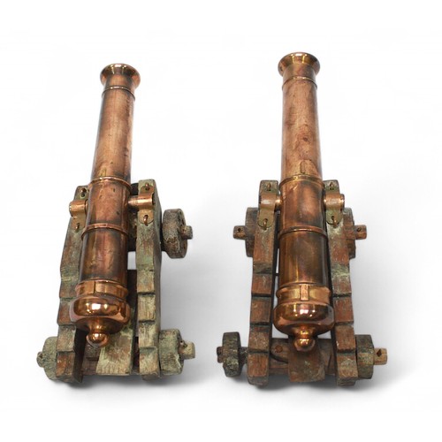 84 - A pair of miniature copper and wooden desk top cannons, 20cm long