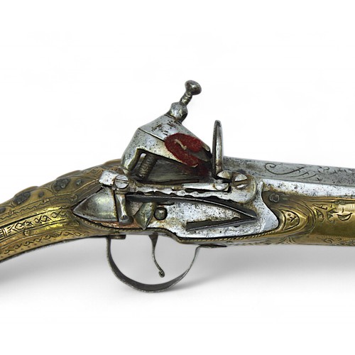 136 - A 19th century Balkan Miquelet flintlock pistol the full stock and rat tail butt clad with engraved ... 