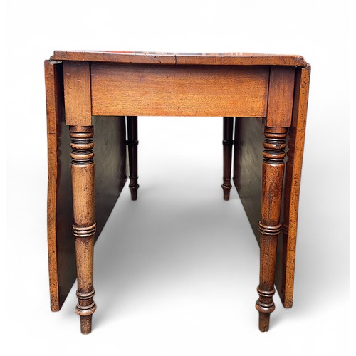 767 - An early 19th century mahogany drop-leaf dining table with rectangular top, on four turned and taper... 