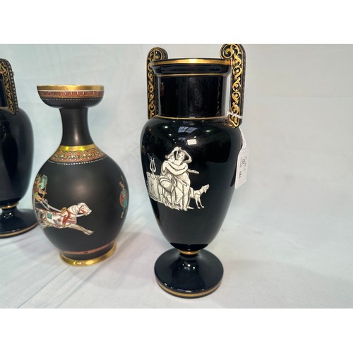 67 - A pair of late 19th Century glazed terracotta amphora vases, black glaze and decorated with neo-clas... 