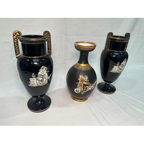 67 - A pair of late 19th Century glazed terracotta amphora vases, black glaze and decorated with neo-clas... 