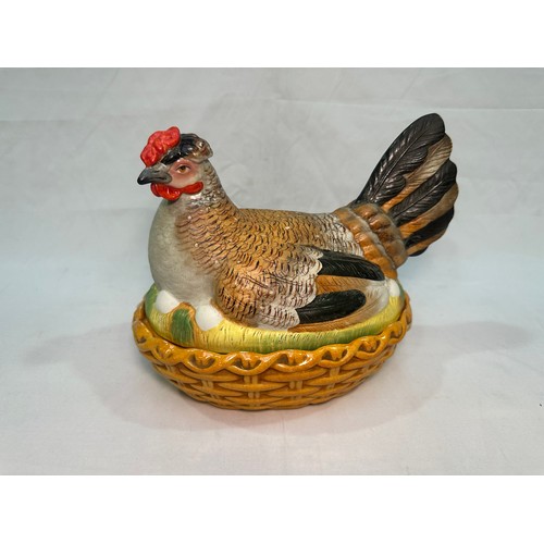 69 - A late 19th century Staffordshire Pottery egg basket modelled as a hand-painted hen on its glazed wi... 