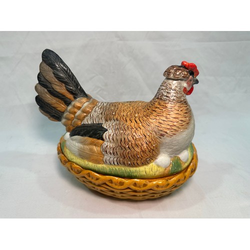 69 - A late 19th century Staffordshire Pottery egg basket modelled as a hand-painted hen on its glazed wi... 