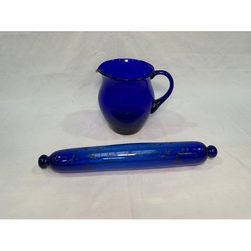 73 - A Bristol blue glass rolling pin printed with text, ships and anchor, 37cm, together with a Bristol ... 