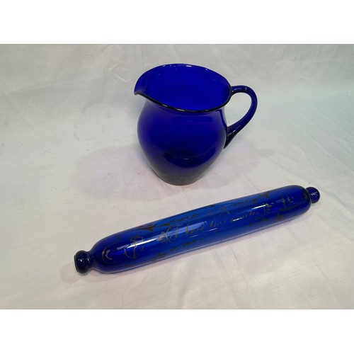 73 - A Bristol blue glass rolling pin printed with text, ships and anchor, 37cm, together with a Bristol ... 