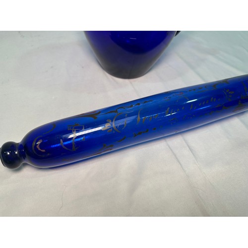 73 - A Bristol blue glass rolling pin printed with text, ships and anchor, 37cm, together with a Bristol ... 