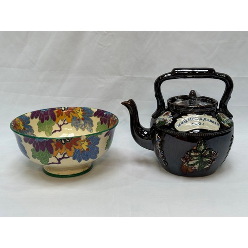 109 - A 'Bargeware' treacle glaze teapot, dated 1921, together with a Royal Doulton 'Gloria' pattern rose-... 