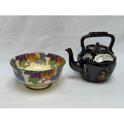 109 - A 'Bargeware' treacle glaze teapot, dated 1921, together with a Royal Doulton 'Gloria' pattern rose-... 