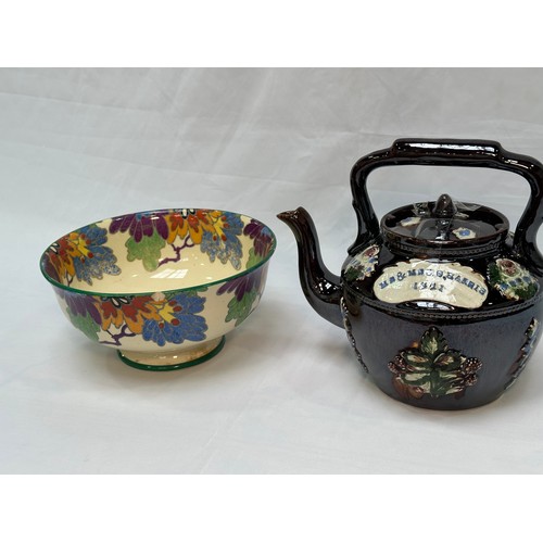 109 - A 'Bargeware' treacle glaze teapot, dated 1921, together with a Royal Doulton 'Gloria' pattern rose-... 