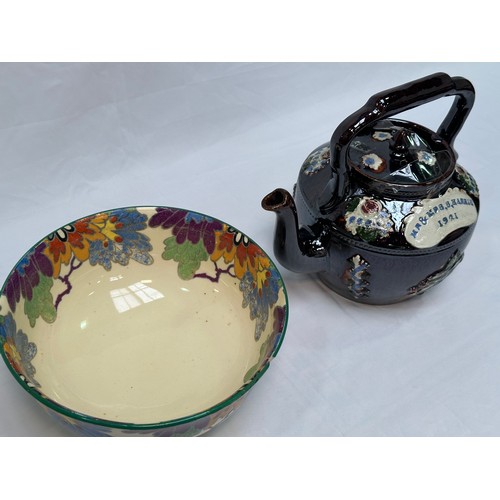 109 - A 'Bargeware' treacle glaze teapot, dated 1921, together with a Royal Doulton 'Gloria' pattern rose-... 