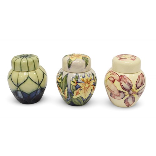 125 - Three assorted Moorcroft pottery ginger jars and covers including one in the ‘Windrush’ pattern desi... 