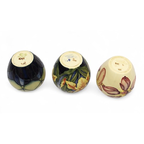 125 - Three assorted Moorcroft pottery ginger jars and covers including one in the ‘Windrush’ pattern desi... 