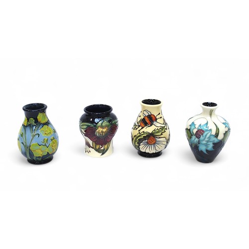 130 - A group of four assorted small Moorcroft pottery vases, including one of tapering cylindrical form w... 