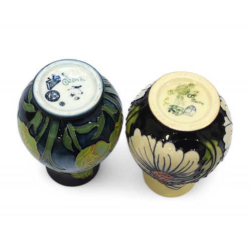 130 - A group of four assorted small Moorcroft pottery vases, including one of tapering cylindrical form w... 