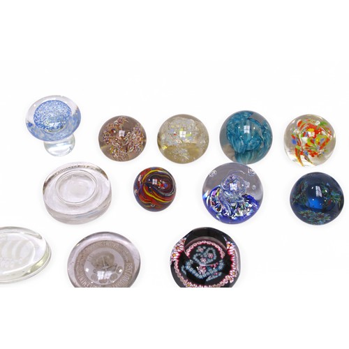 135 - A collection of 15 assorted glass paperweights, including some Caithness examples, one in original f... 