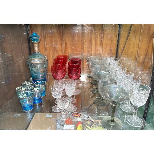 136 - A set of six cranberry glasses, a blue glass liquor set, some Dartington glasses and Webb crystal cu... 