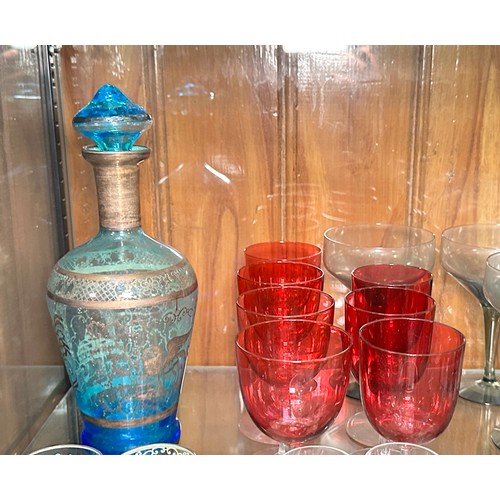 136 - A set of six cranberry glasses, a blue glass liquor set, some Dartington glasses and Webb crystal cu... 