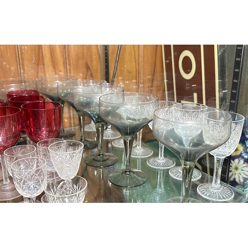 136 - A set of six cranberry glasses, a blue glass liquor set, some Dartington glasses and Webb crystal cu... 