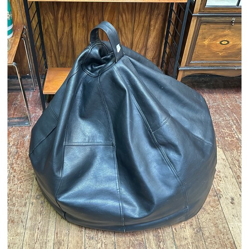 646 - A large, black grain leather beanbag, with loop handle to top.