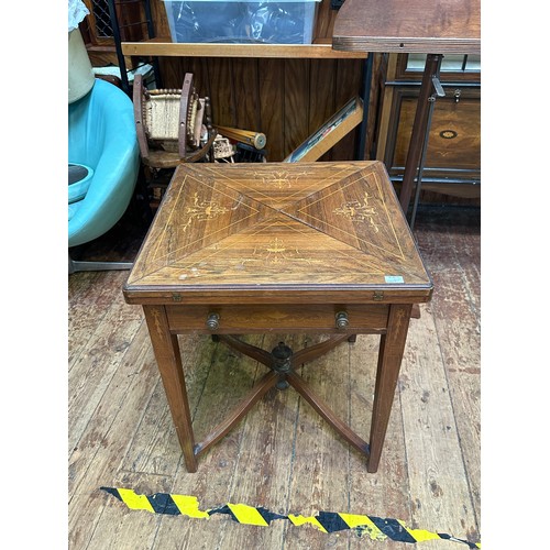 644 - An Edwardian rosewood envelope card table, of typical form, with inlaid top, enclosing green playing... 