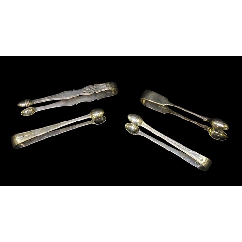 185 - Four 18th and 19th Century silver sugar tongs, comprising a Victorian example, of plain design, by G... 