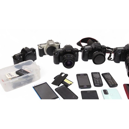 450 - A large collection of assorted SLR film cameras, lenses and accessories - cameras including Canon EO... 