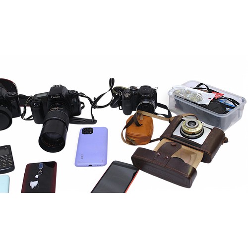 450 - A large collection of assorted SLR film cameras, lenses and accessories - cameras including Canon EO... 