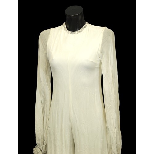 111 - Stage Wear / Evening Wear: Three garments, 
c. 1970s, 
including: a white maxi dress, of floral net ... 