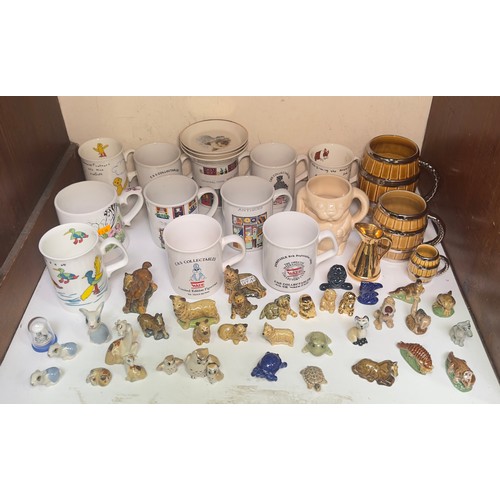 10 - A large collection of approximately ninety Wade Ceramics figures, Whimsies, money boxes, dishes, mug... 