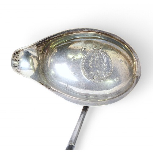 155 - A George III silver toddy ladle by John Merry, the bowl with shaped spout and set with George II sil... 