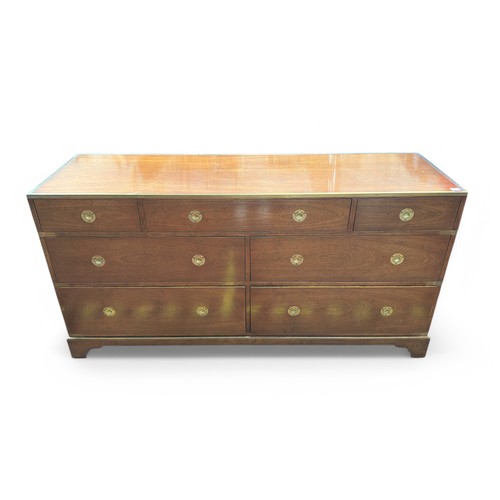 559 - A 20th century mahogany Campaign style chest of seven drawers, with brass top edge, binding and flus... 