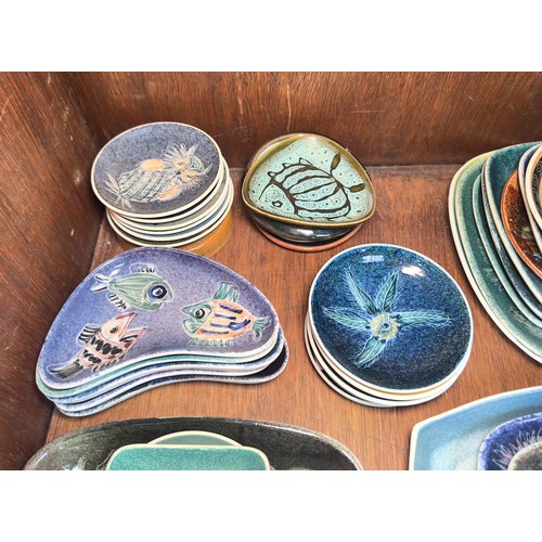 50 - A large collection of Isle of Wight pottery plates and pin dishes, etc., examples predominantly by J... 