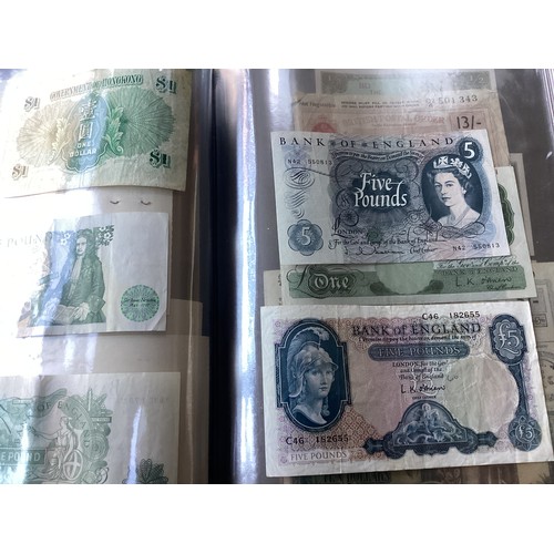 303 - Two albums containing approximately 90 world banknotes, but also a few British notes, cheques a 1910... 