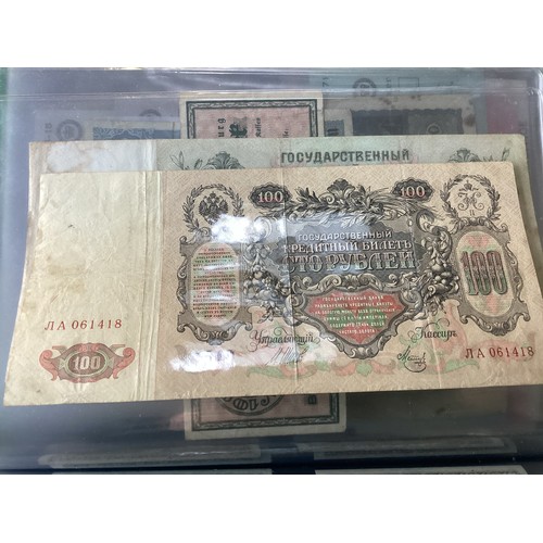 303 - Two albums containing approximately 90 world banknotes, but also a few British notes, cheques a 1910... 