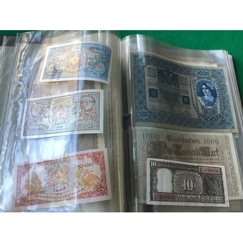 303 - Two albums containing approximately 90 world banknotes, but also a few British notes, cheques a 1910... 