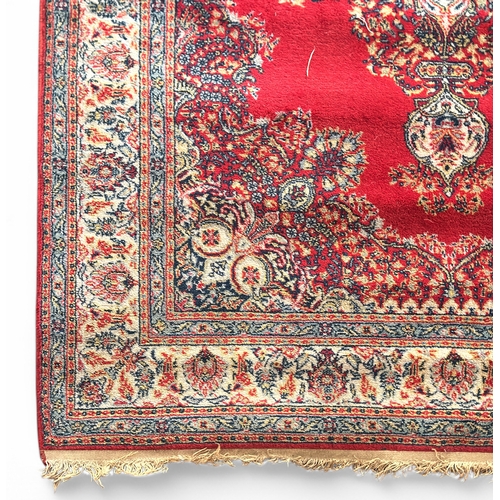 491 - A hand-knotted woollen rug, with central medallion worked to a red ground within Shah Abbas border, ... 