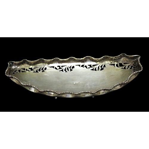 169 - A .800 grade silver pierced oval sweetmeat/bon-bon dish, with crimped edge and raised on leaf moulde... 