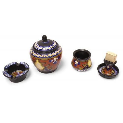 100 - A Gouda pottery smoking set comprising oval tray, tobacco jar & cover, matchbox holder, ashtray and ... 