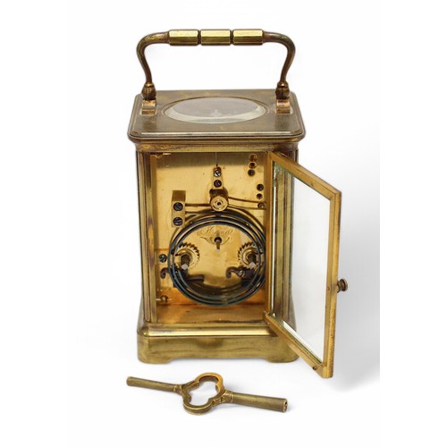 461 - A large brass cased carriage clock, the white enamel dial with Roman numerals denoting hours, expose... 