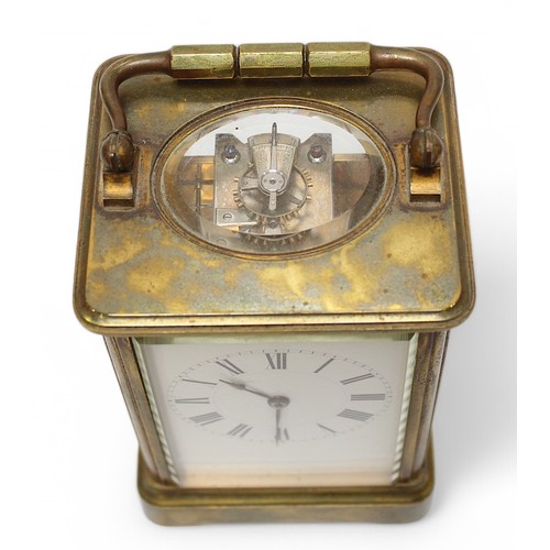 461 - A large brass cased carriage clock, the white enamel dial with Roman numerals denoting hours, expose... 