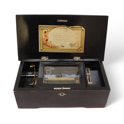 385 - A 19th century ebonised Swiss music box, playing 6 airs, with paper airs list to inside of cover, to... 