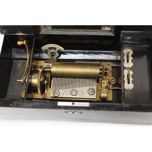 385 - A 19th century ebonised Swiss music box, playing 6 airs, with paper airs list to inside of cover, to... 